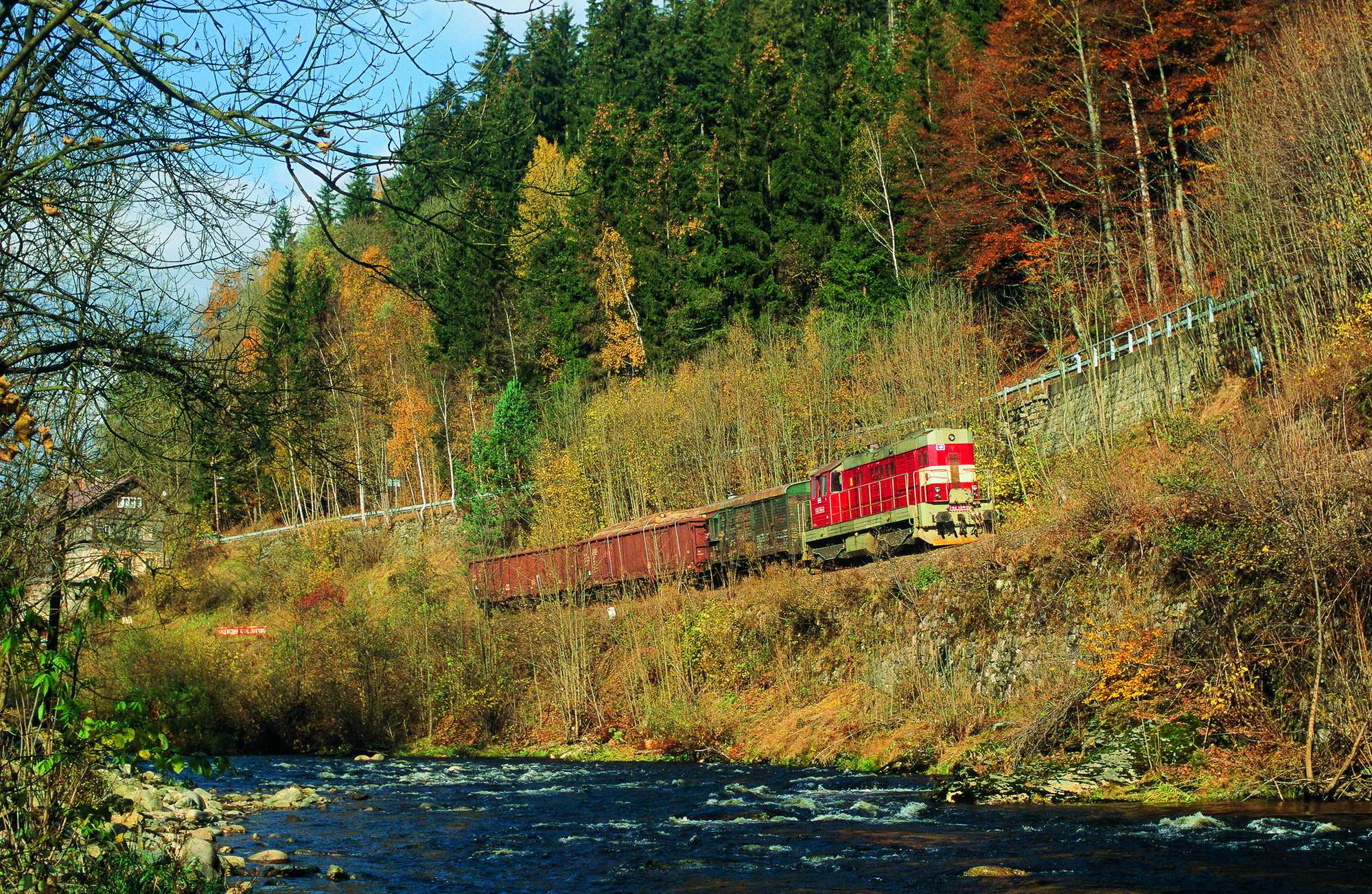 Diesen aus mit Holzstämmen beladenen vierachsigen Wagen gebildeten Güterzug fotografierte Andreas W. Petrak im Oktober 2009 zwischen Rokytnice und Jablonec nad Jizerou im idyllischen Isertal.