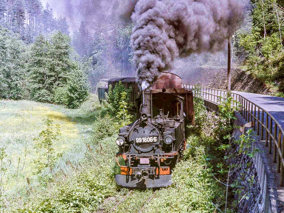 Im Frühjahr 1985 waren die Gleise der Schmalspurbahn kaum noch zu sehen, als sich die IV K 99 1606-5 mit ihrem Güterzug dem damaligen Endbahnhof Niederschmiedeberg näherte.