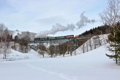 Im Schlepp eines Personenzuges kehrte die Diesellok L45H-083 am 20. Januar 2021 mit dem Schneepflug 97-09-75 von einem Räumeinsatz zurück. Dabei fotografierte sie Julius Walther auf dem Hüttenbachviadukt kurz vor dem Endpunkt der Fichtelbergbahn in Oberwiesenthal.