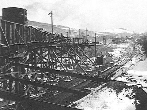 Die Holzbrücke der Feldbahn über die noch eingleisige Strecke zur Geländeanschüttung unterhalb des Bahnbetriebswerkes.